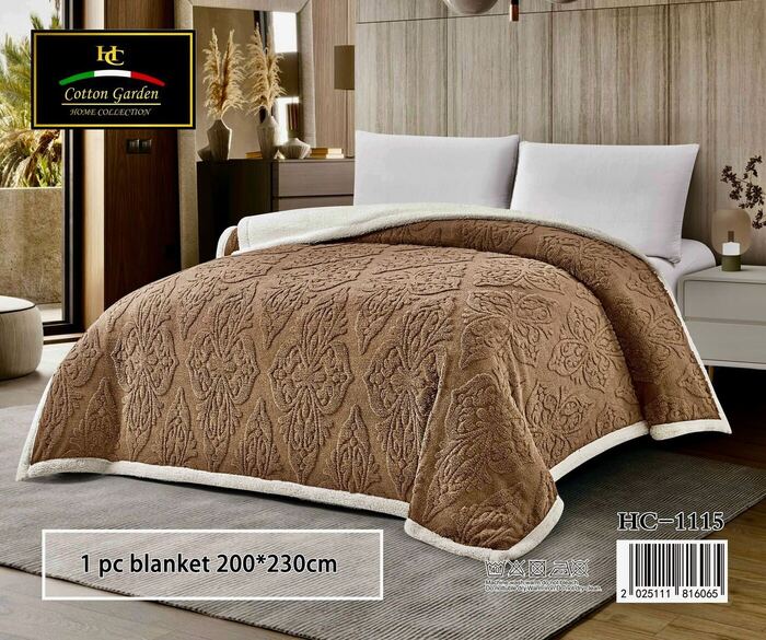 Cotton Garden embossed blanket in brown on a bed, cream reverse side