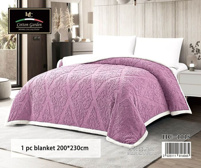 Cotton Garden embossed blanket in mauve on a bed, cream reverse side