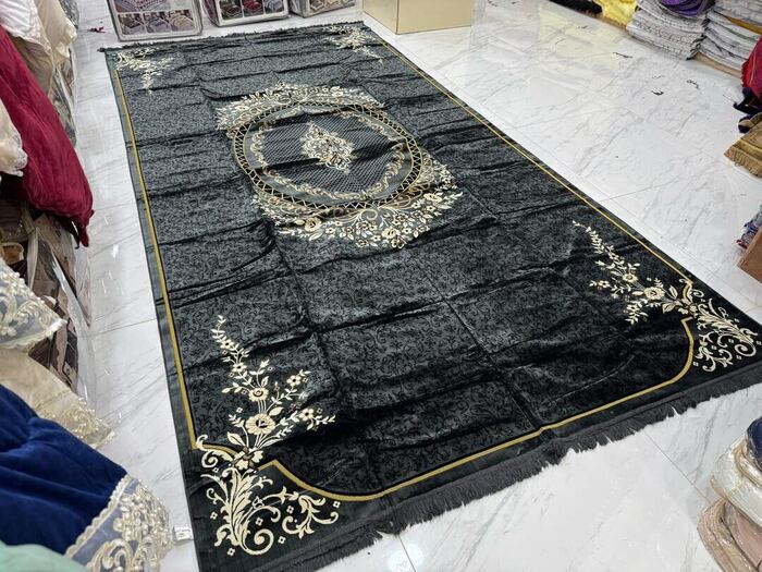 Black and gold traditional woven rug with ornamental medallion